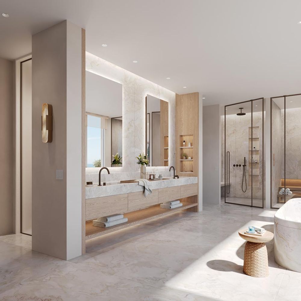 Luxury marble bathroom with double vanity, backlit mirrors, and glass shower
